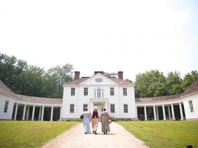 people in costume walking to the blennerhassett mansion