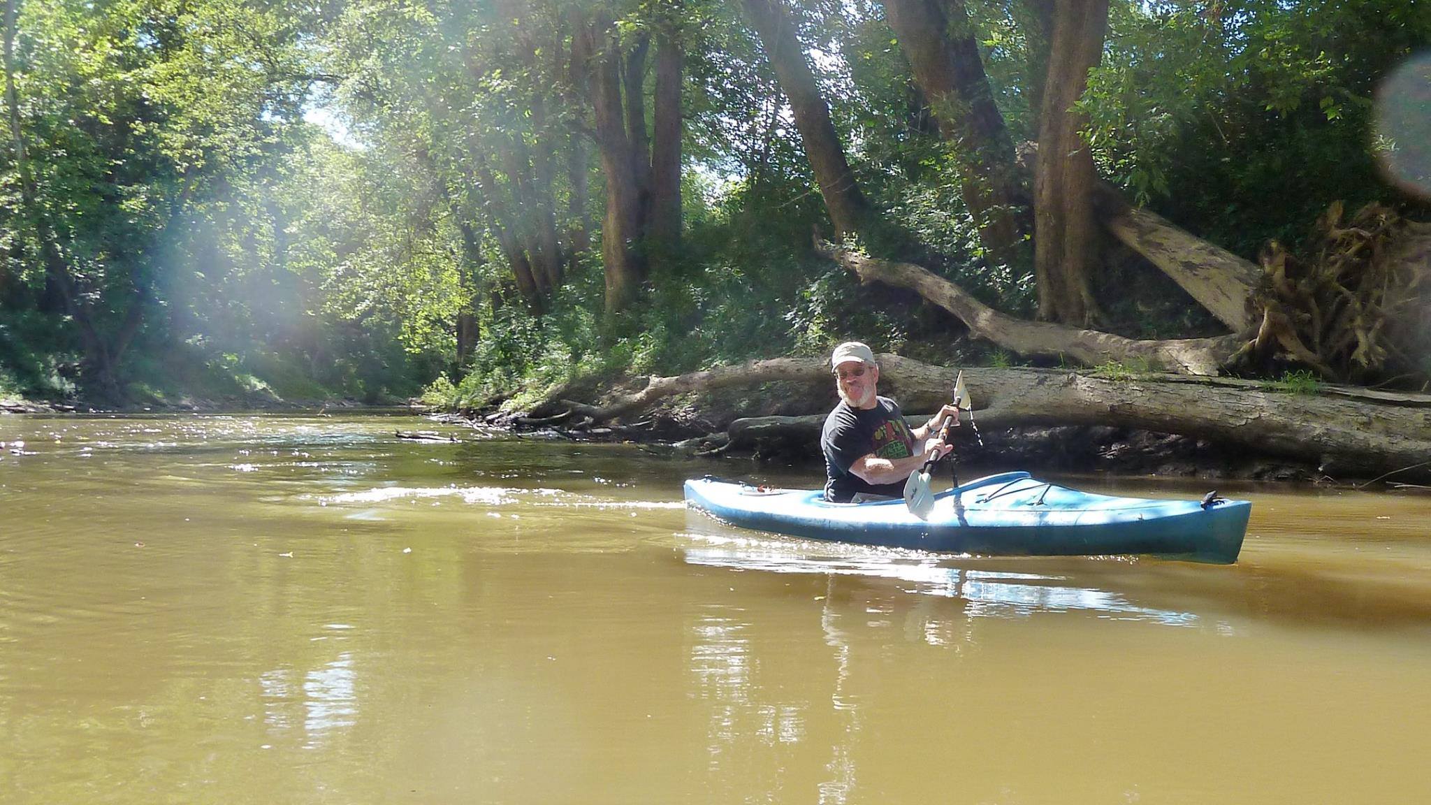 kayaking on a river and smiling