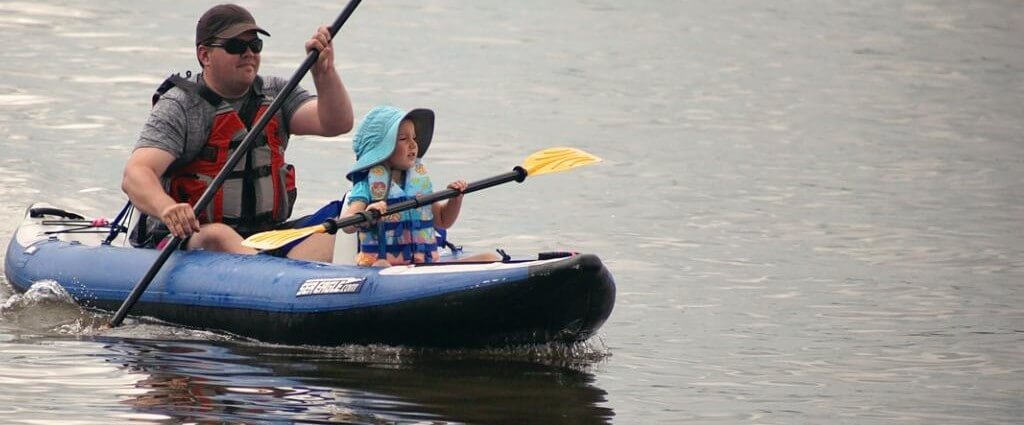 people in a kayak in open water