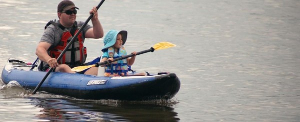 people in a kayak in open water