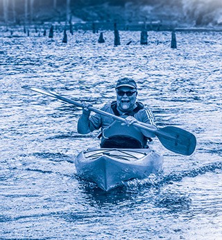 Paddling a kayak in a lake