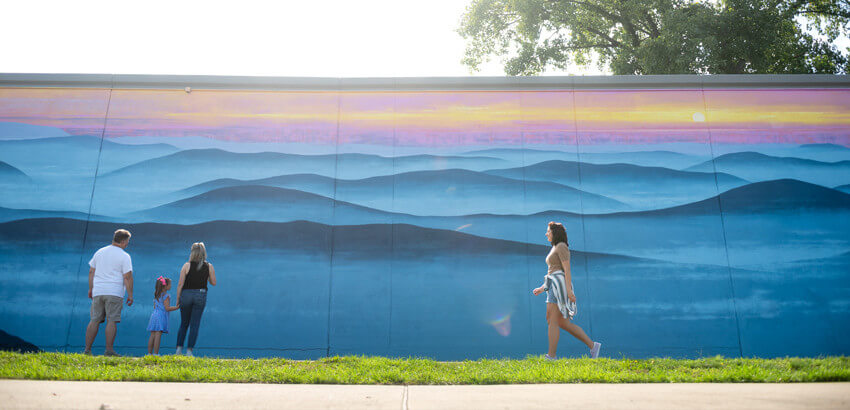 Parkersburg flood wall mual of mountains and sunrise