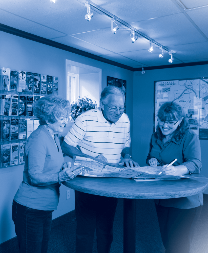 People standing a a desk smiling